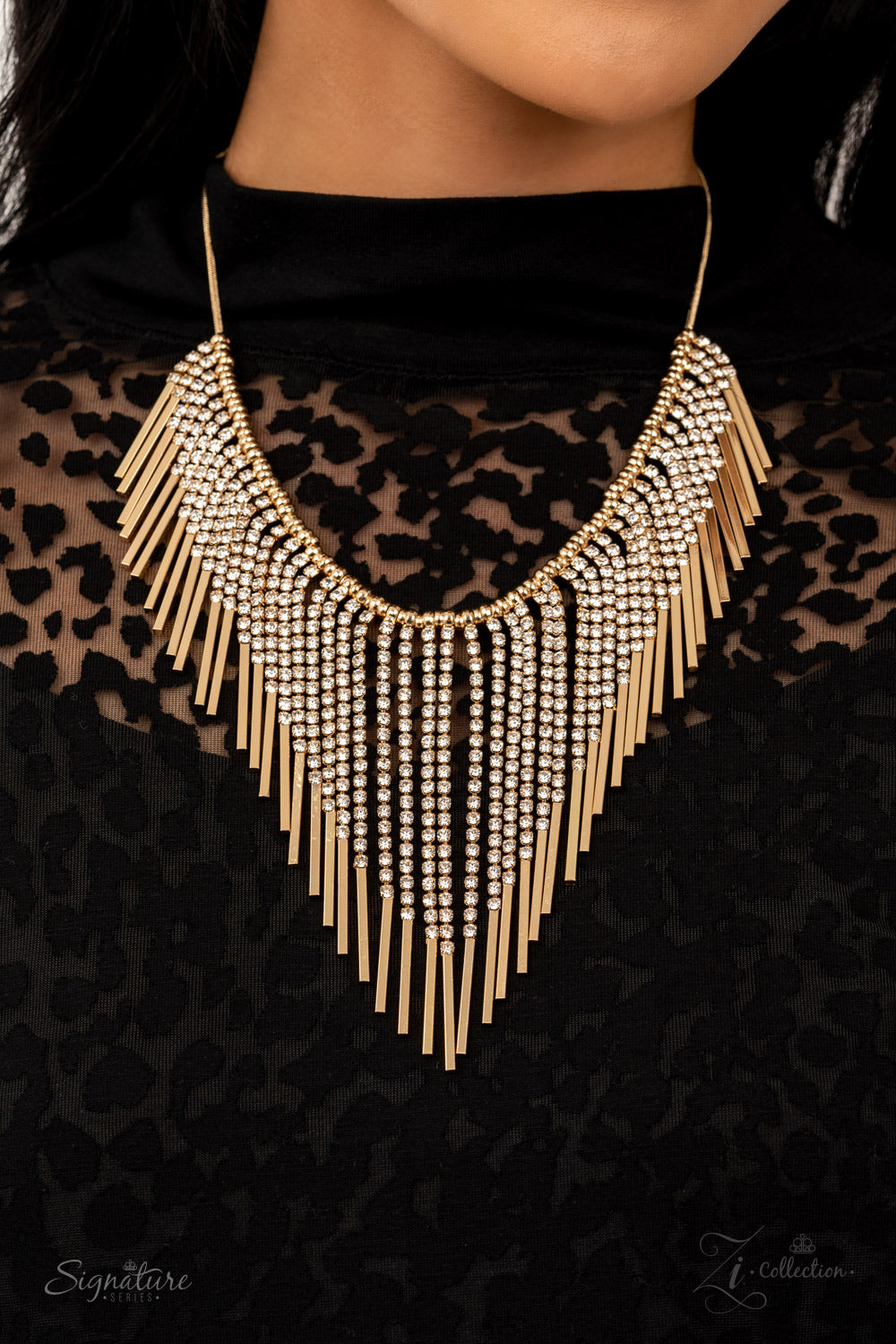 Paparazzi The Amber 2021 Zi Collection Gold Necklace Gold beads, strandsa of white rhinestones morph into gold rectangular frames along a snake chain. The golden getup stacks into tapered tassels, creating a fringe. ​Sold as one individual necklace. Includes one pair of matching earrings. Zi Collection Paparazzi