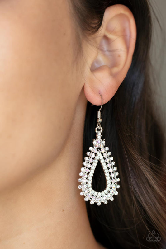 Paparazzi The Works - Multicolor Earrings White, iridescent, and opal rhinestones stack into a solitaire sparkly teardrop frame for a glamorous fashion. Earring attaches to a standard fish hook earring backs. Sold as one pair of multicolor earrings. Free Shipping on orders over $75