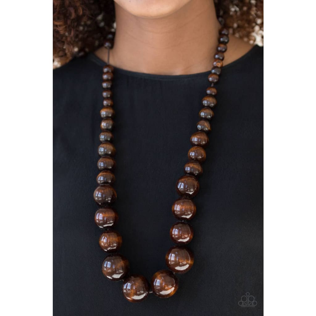 Paparazzi Effortlessly Everglades - Brown Necklace  Gradually increasing in size near the center, earthy wooden beads are threaded along a brown string for a summery look. Features an adjustable sliding knot closure.  Sold as one individual necklace. Includes one pair of matching earrings.  Paparazzi Accessories are all Lead Free and Nickel Free- A Finishing Touch 